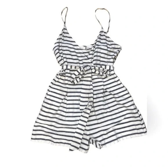 Billabong cream, black and white striped romper. Never worn size medium.